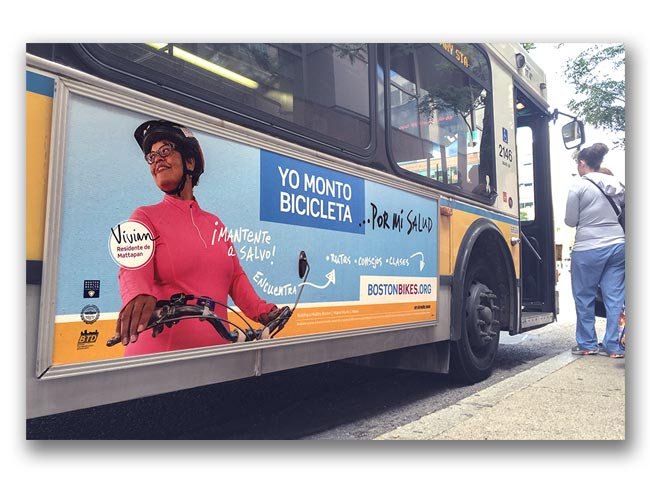 Photo of Let's Get Healthy Boston bike campaign poster on the side of a bus